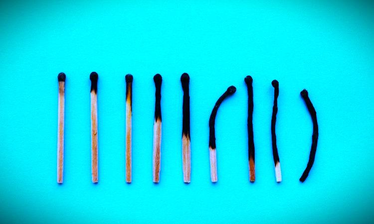 a row of matches on a blue background, burnout